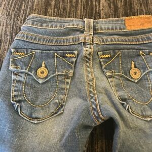 True Religion Blue Jeans with Distinctive Stitching and Faded Wash
